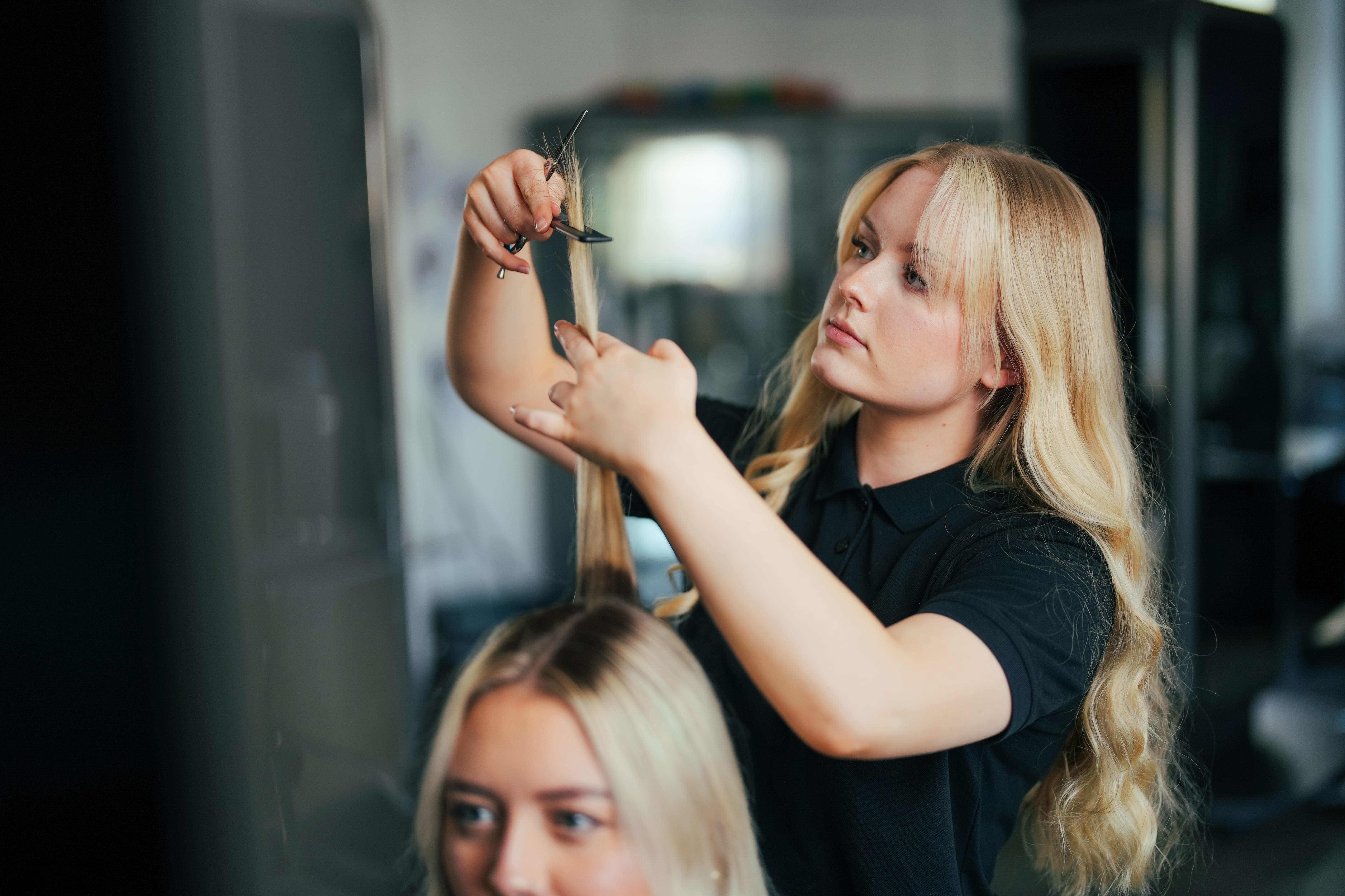 girl practices her hairdressing on model