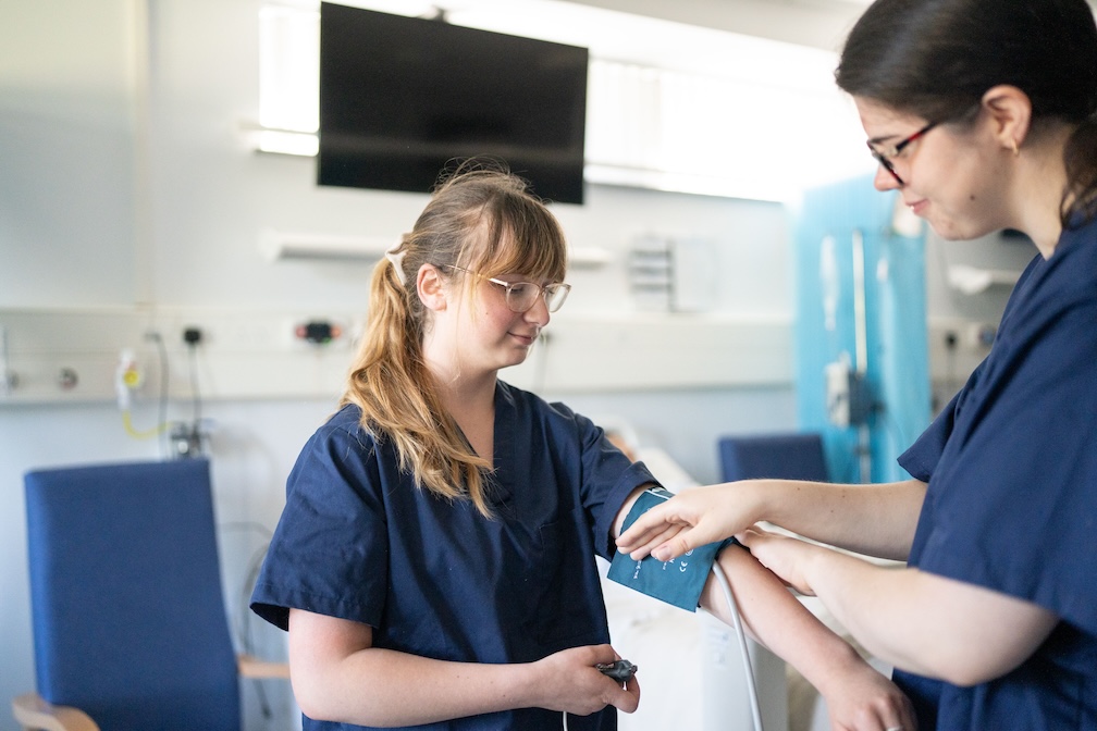 nursing student taking blood pressure from other nursing student