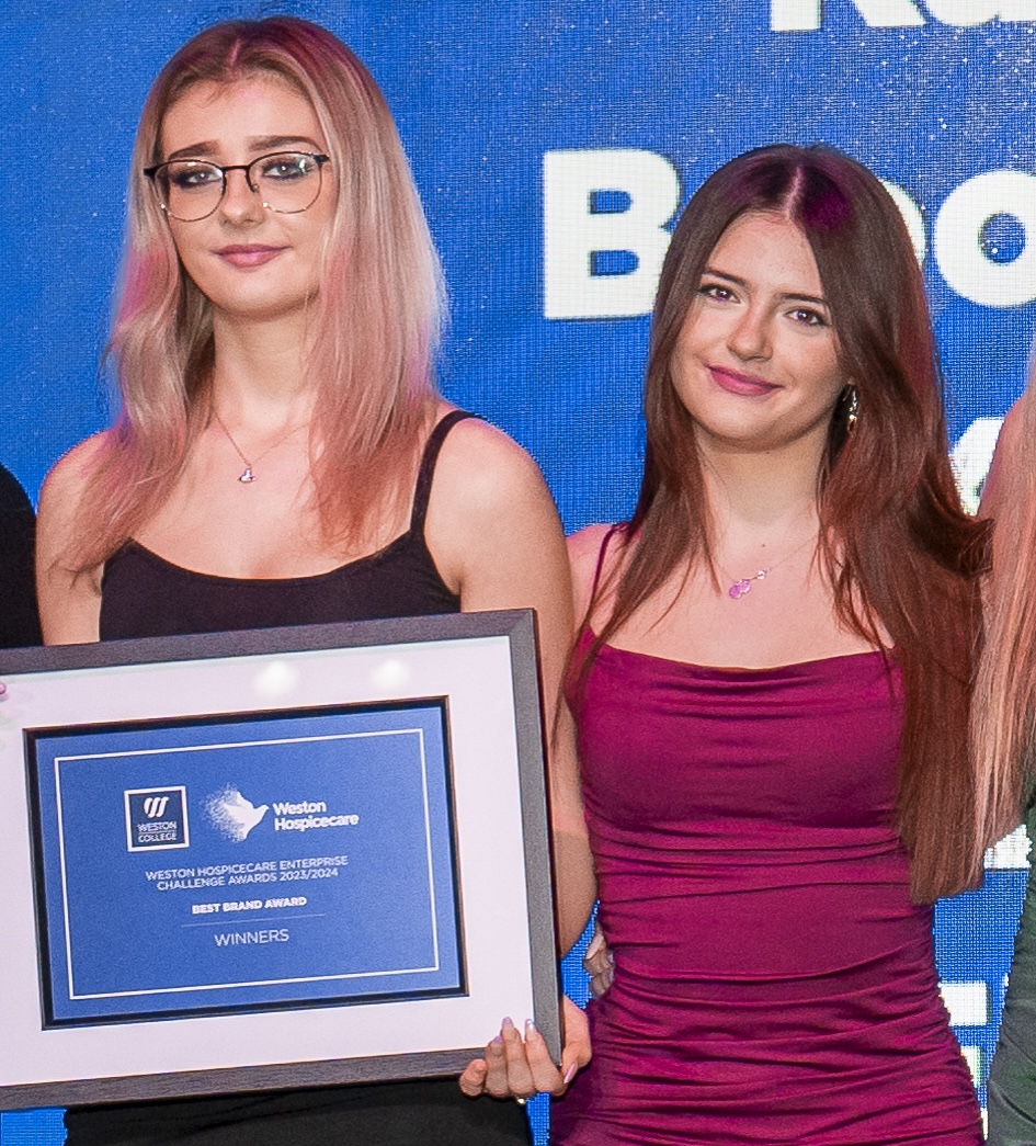 kyala lanning and brooke lewinton standing with a certificate