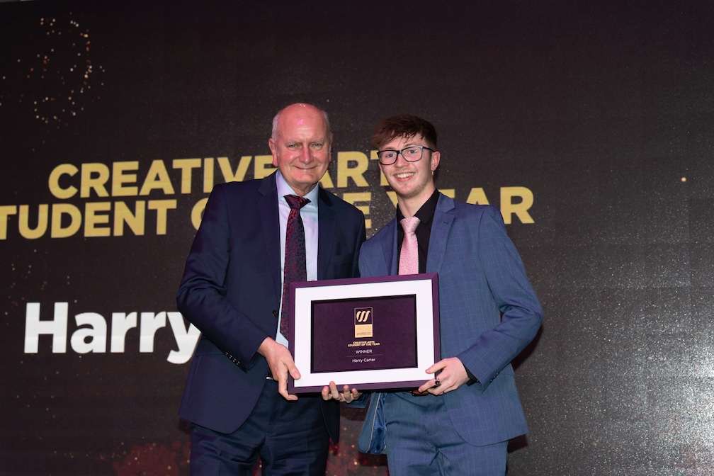 harry carter accepting his celebration of success award