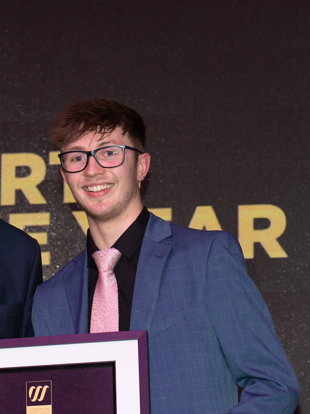 harry carter accepting his celebration of success award