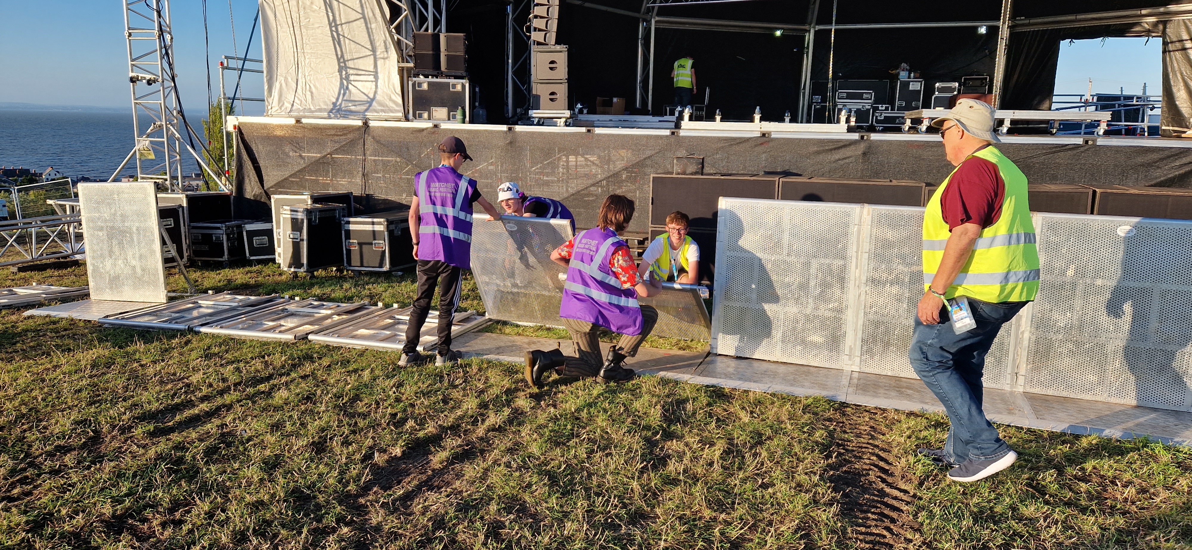 Volunteers putting up barrier in front of stage