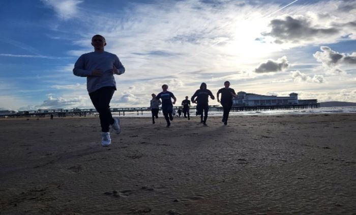Learners running on the beach in Weston-super-Mare