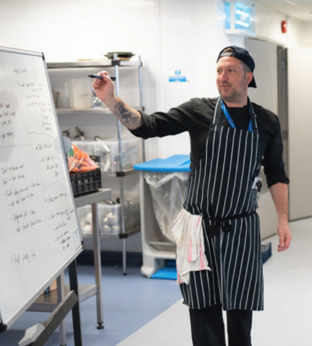 photo of peter goodship teaching on a whiteboard