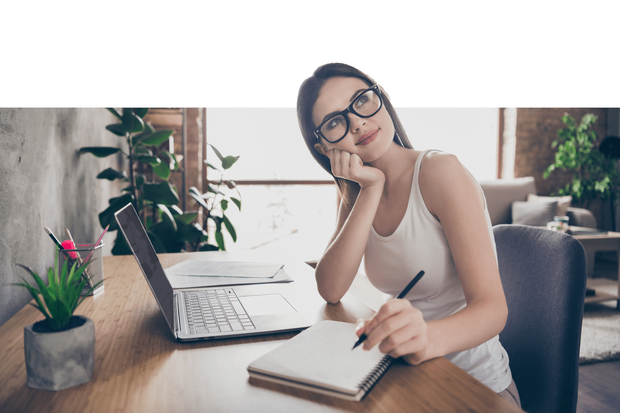 women sitting down thinking while writing on a note pad