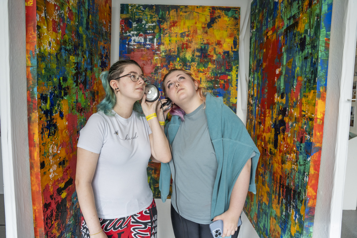 two girls look at art