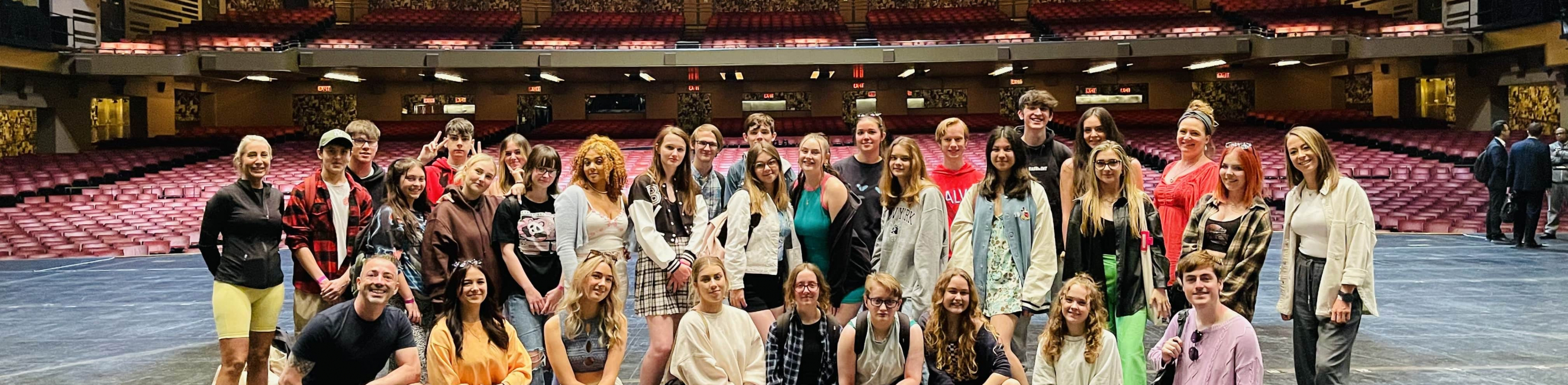 performing arts students stood on theatre stage in Broadway in new york