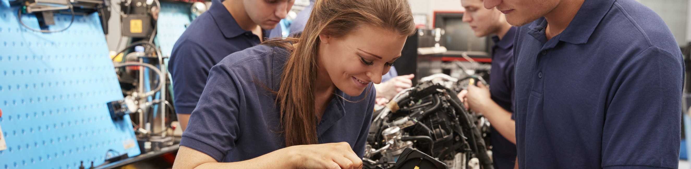 Two students looking at an engine