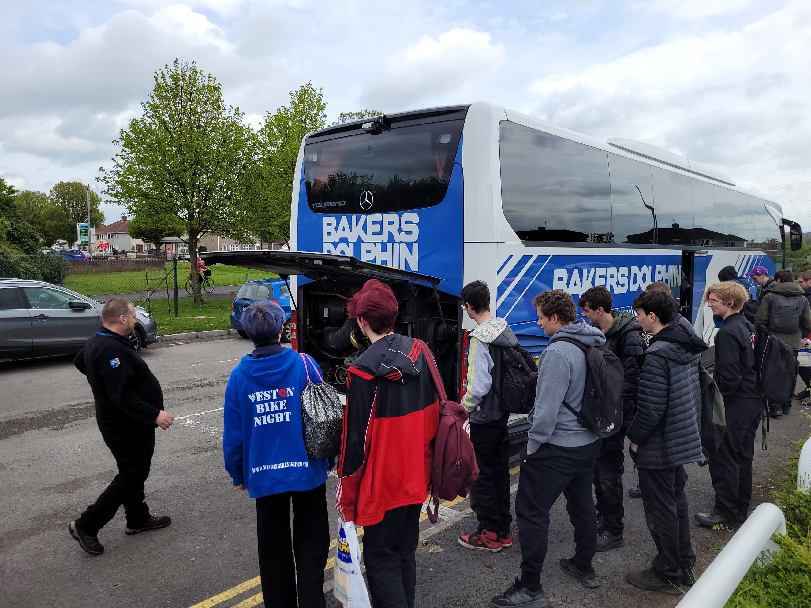 Bakers Dolphin team showing our students their coaches engine