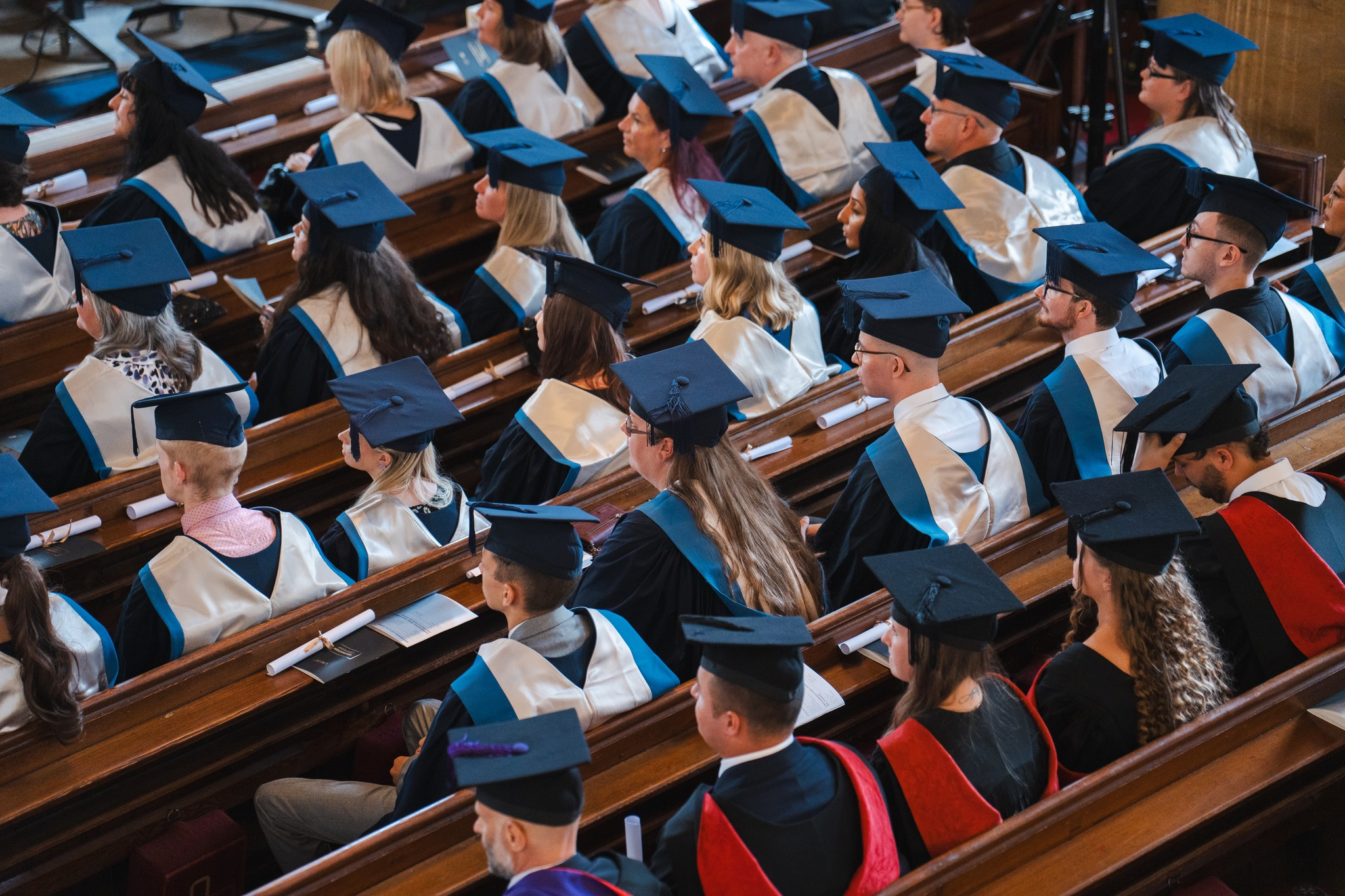 Students sat in Graduation caps and gowns