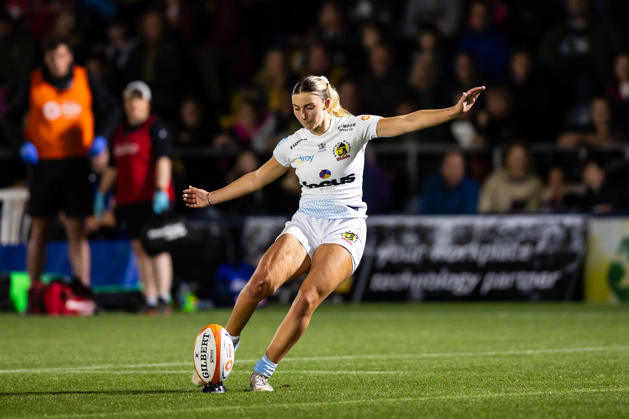 Lottie kicking a rugby ball