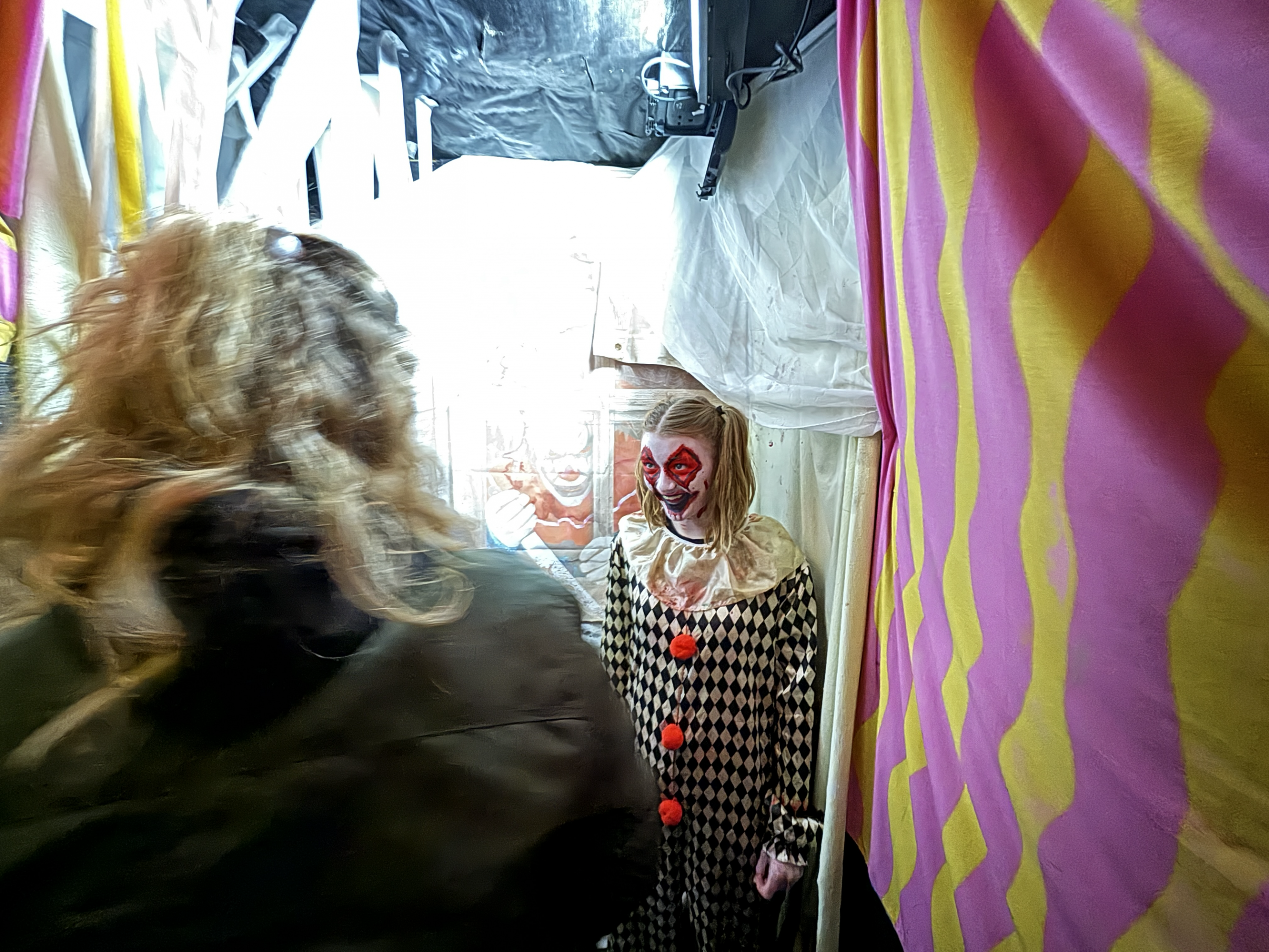 Performing Arts student dressed as a clown and scaring the public