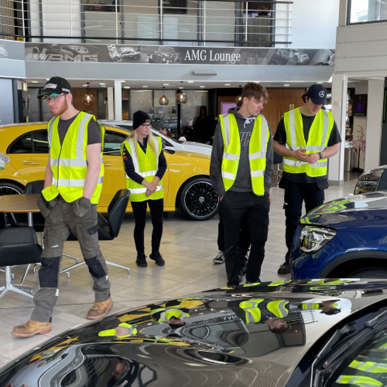 Motor vehicle learners exploring Mercedes-Benz showroom