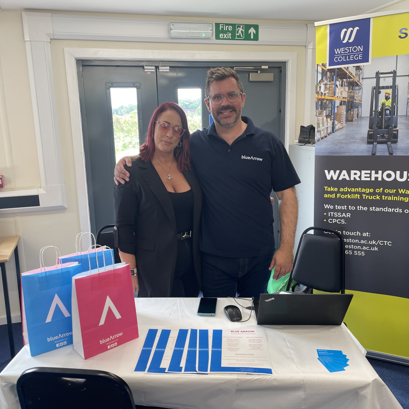 Two people standing arm in arm at the HGV careers fair