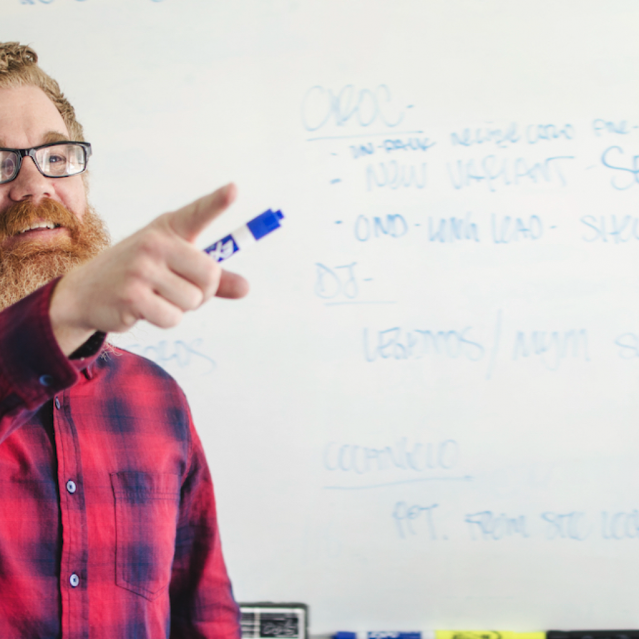 male teacher pointing at whiteboard