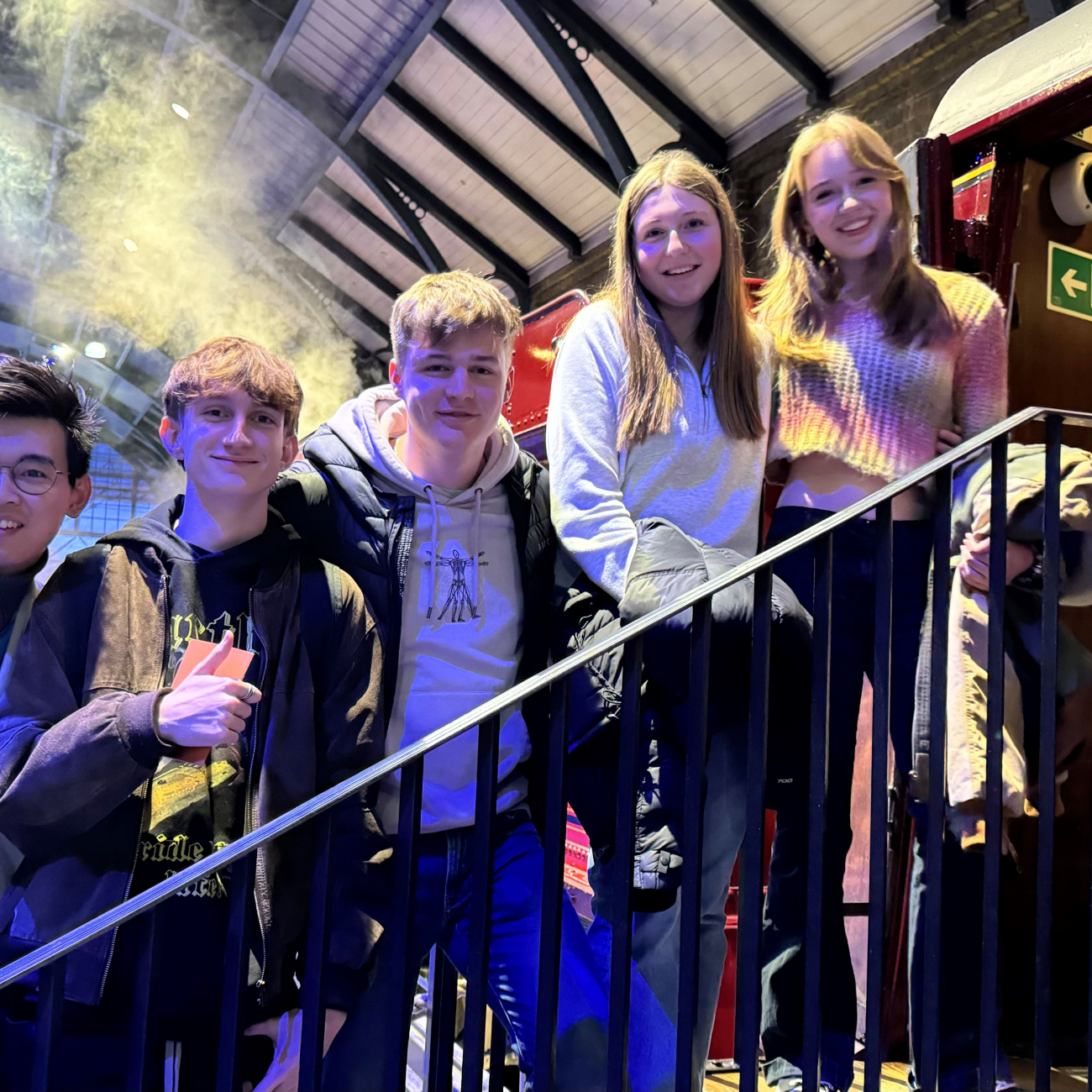 Students and lecturer on train at harry potter studios