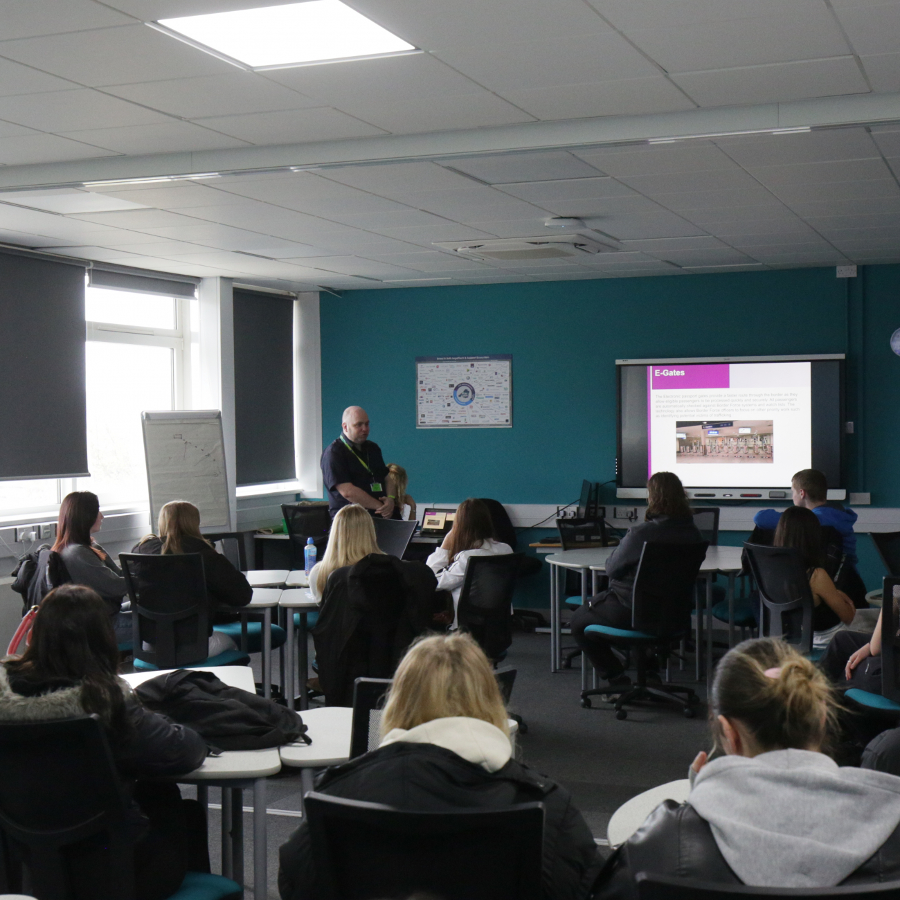 travel and tourism students receiving a lecture from the border force