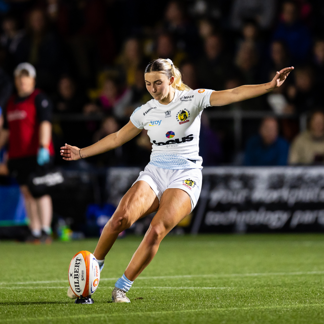 Lottie kicking a rugby ball