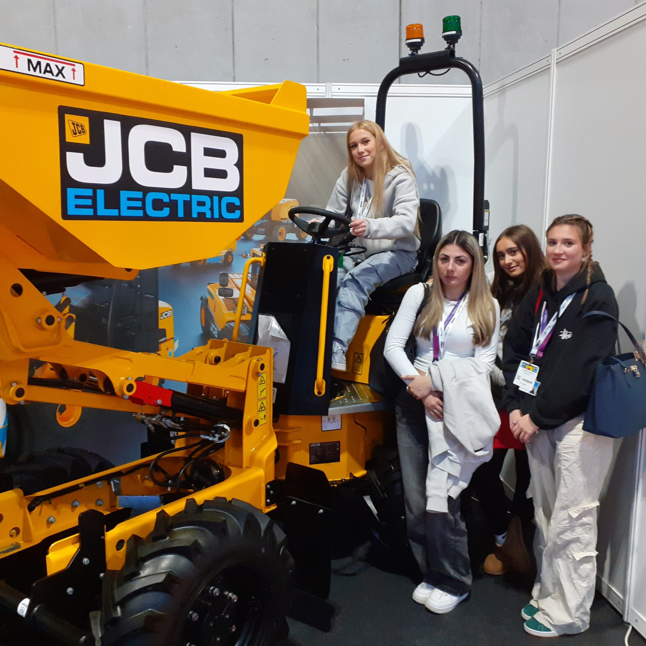 Learners standing around a JCB digger