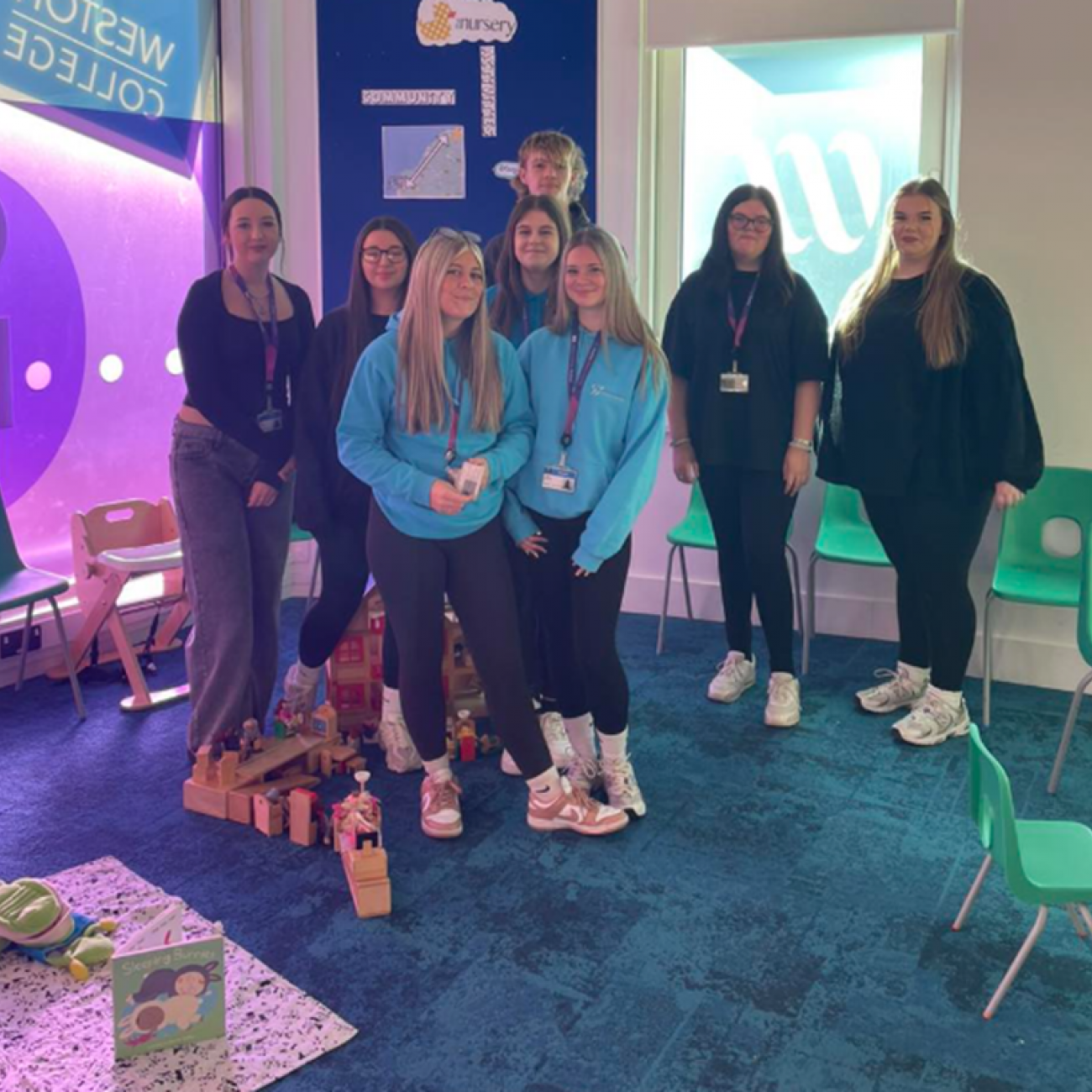 A group of Early Years learners smiling in the early years classroom