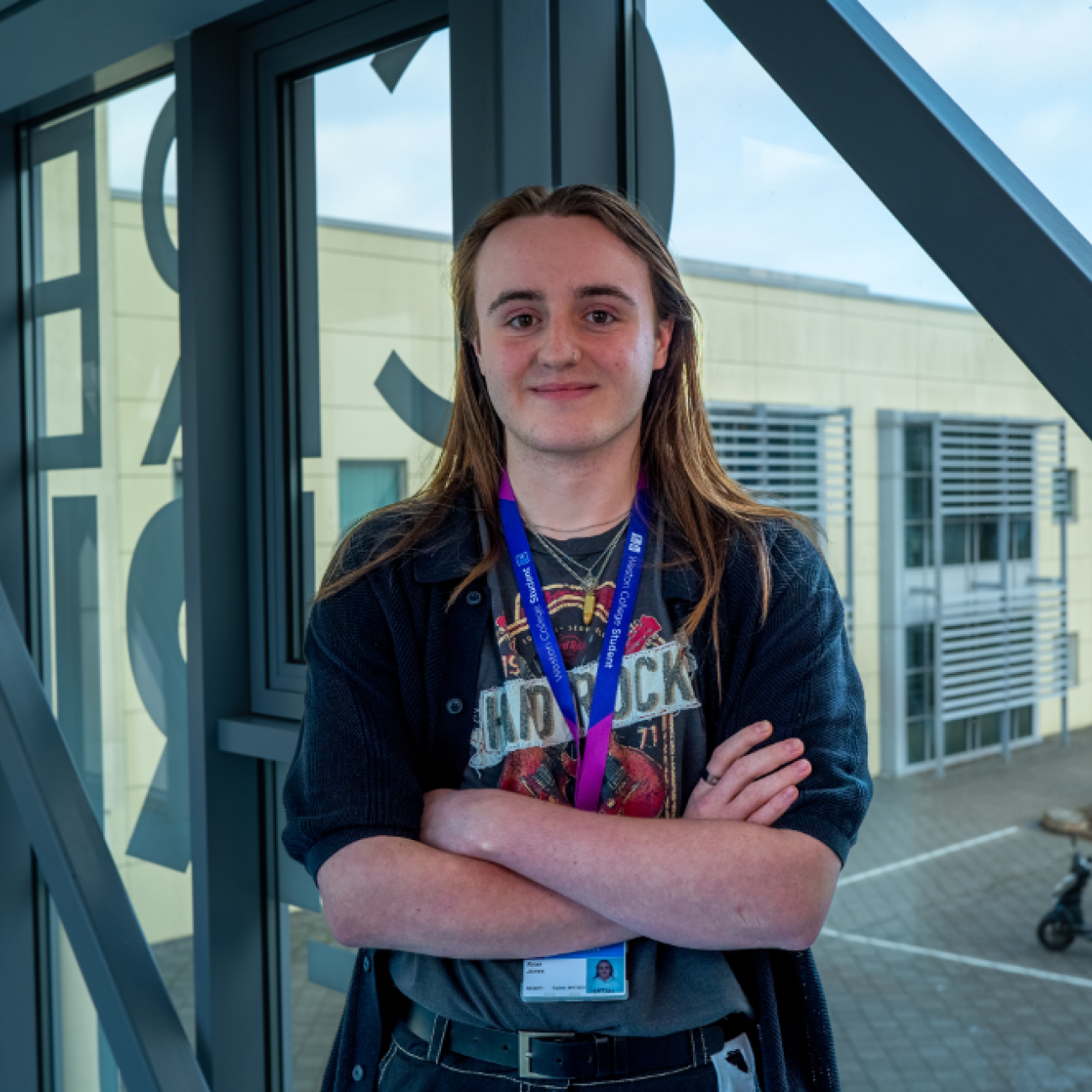 Sixth Form learner, Ryan, standing smiling on the Sixth Form bridge