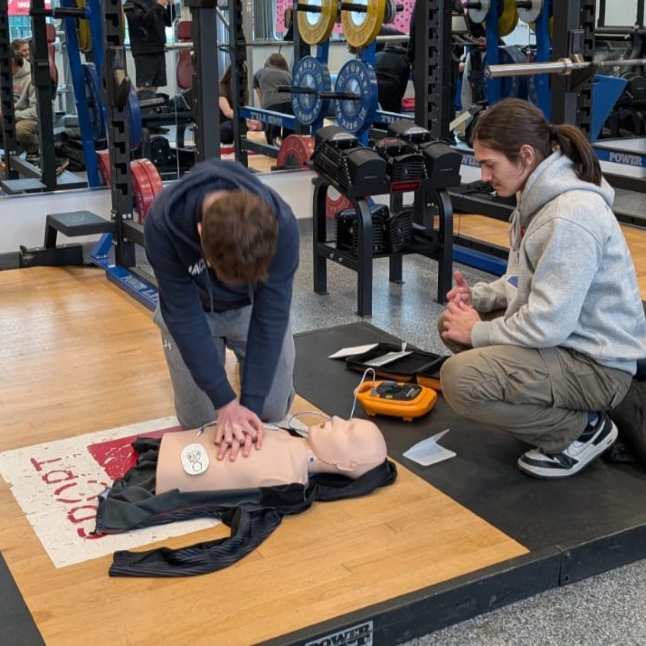 Student practicing CPR on a dummy