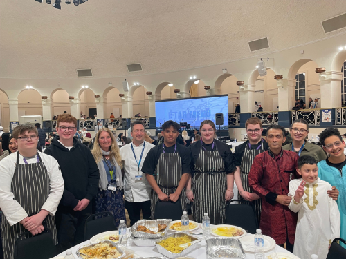 Hospitality and Catering students and staff standing smiling with Sayd Ahmed