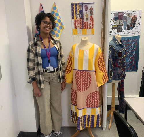 Eden standing next to her final project: a printed dress