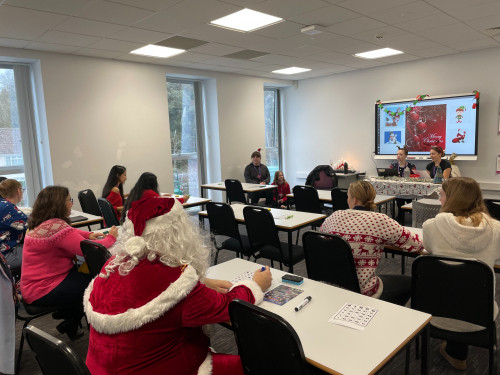 Students and residents playing Christmas Bingo