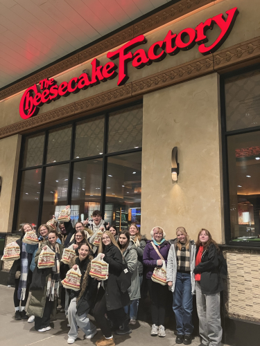 Students standing in front of The Cheesecake Factory