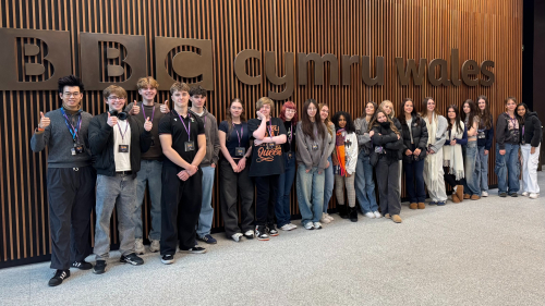 Group photo of the Media learners by the BBC Cardiff sign