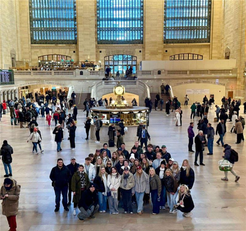 Business and Travel students smiling in Grand Central Station