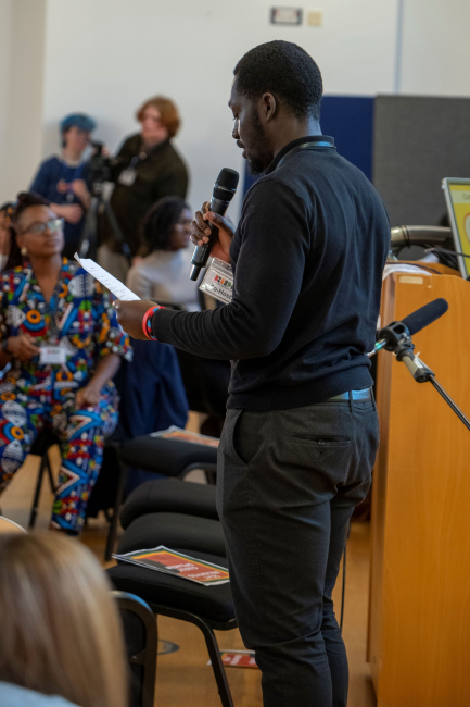 jason serlomey giving a speech at black history month event