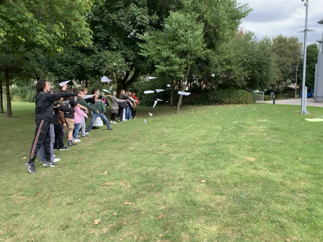 Art students throwing paper planes on their first day