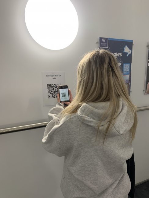 Student scanning a QR code for the scavenger hunt