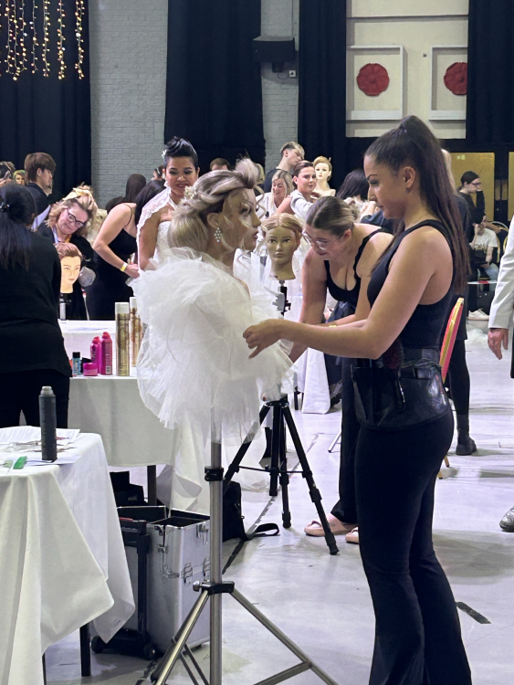 our hair and beauty apprentice, ellie, styling hair at the competition