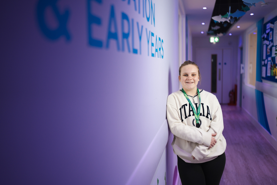 female student standing in early years corridor