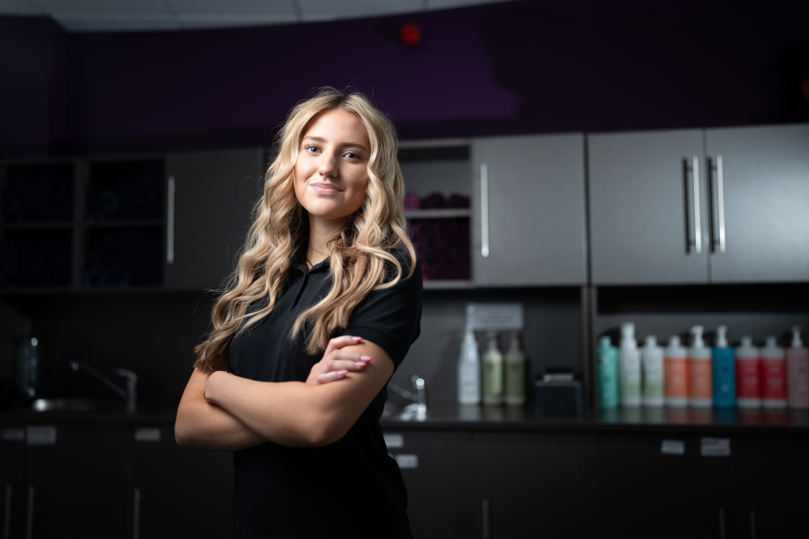 female hair student posing in hair salon